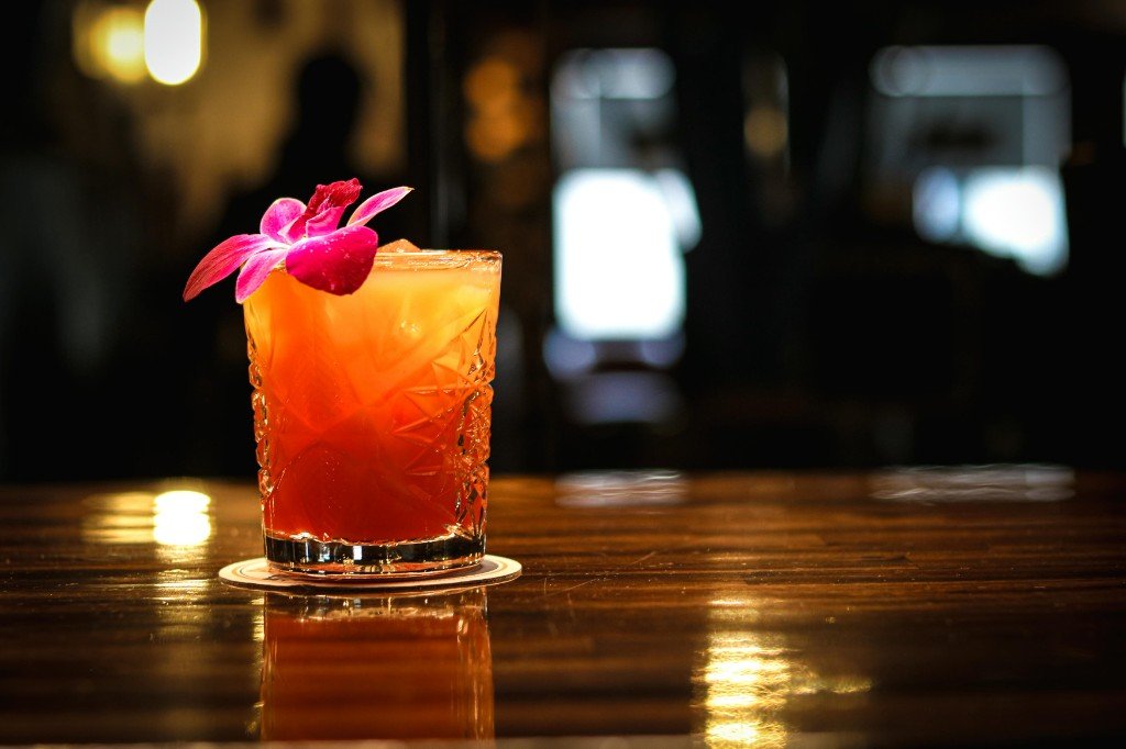 Tropical cocktail with orchid garnish at Tequila Fuego bar Longview Washington