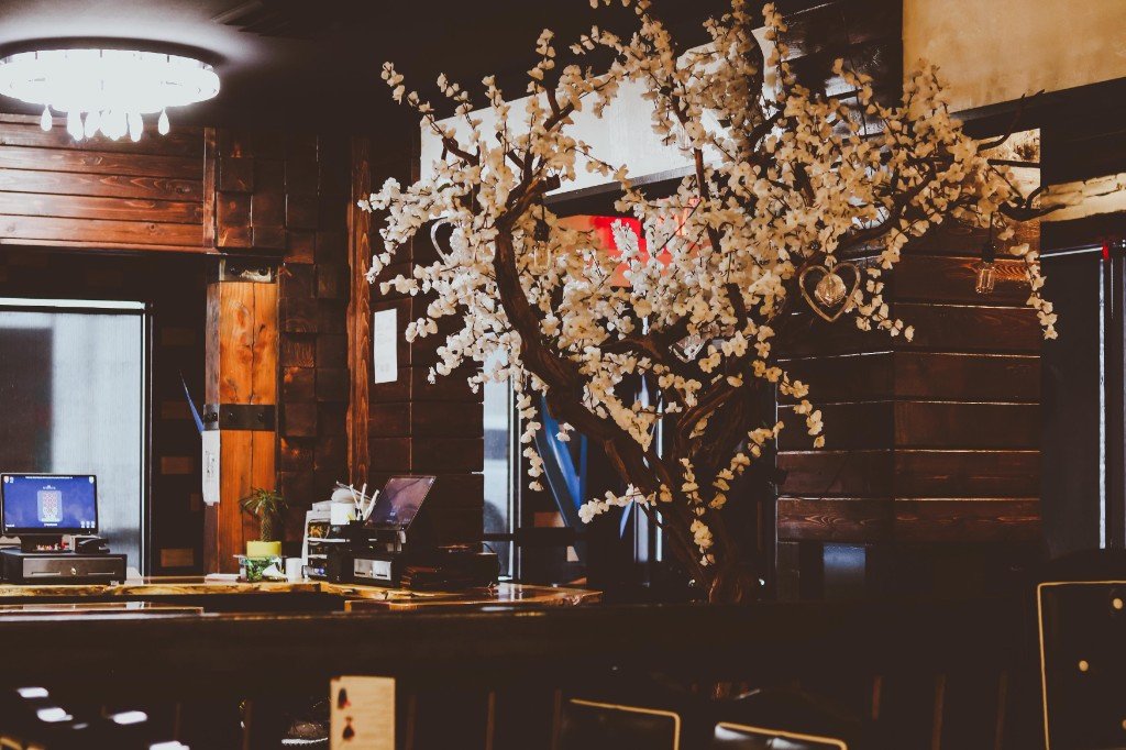 Interior of Tequila Fuego restaurant dark wood paneling decorative cherry blossom tree and counter area Longview WA